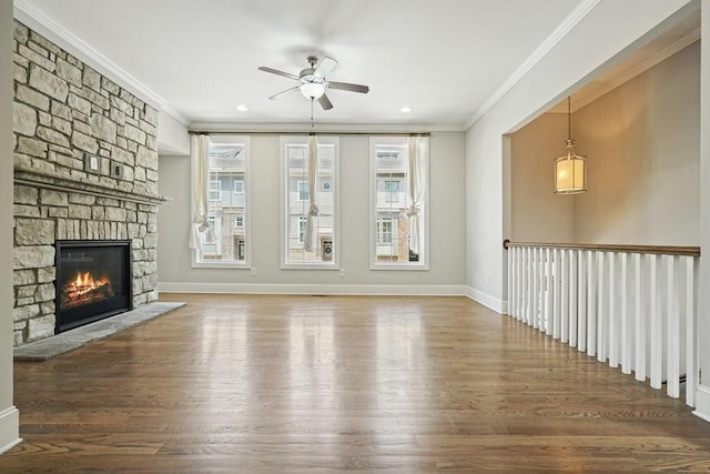 2093 Callaway Ct NW, Atlanta, GA 30318 - unfurnished living room with a ceiling fan, ornamental molding, wood finished floors, a stone fireplace, and baseboards