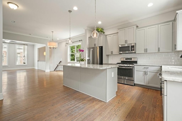 2093 Callaway Ct NW, Atlanta, GA 30318 - kitchen with stainless steel appliances, a center island, decorative backsplash, dark wood-style floors, and crown molding