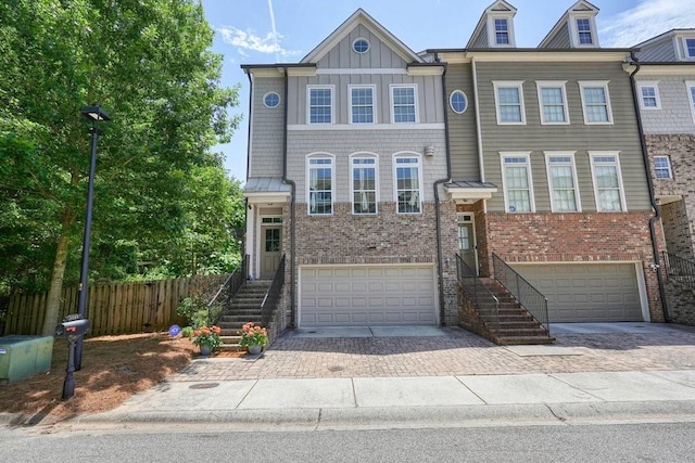 2093 Callaway Ct NW, Atlanta, GA 30318 - view of front facade featuring an attached garage, brick siding, decorative driveway, and stairway