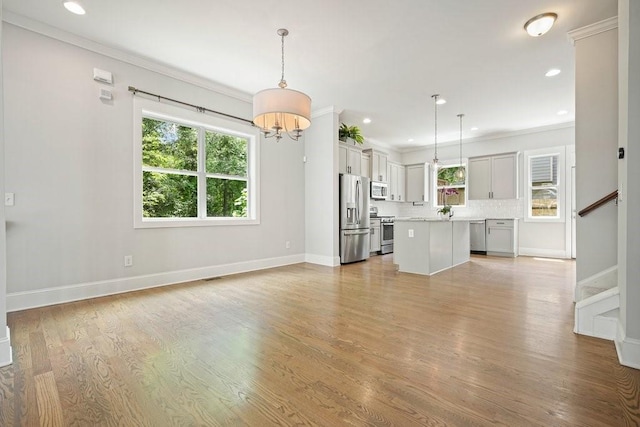 2093 Callaway Ct NW, Atlanta, GA 30318 - unfurnished living room with stairway, a chandelier, light wood finished floors, recessed lighting, and ornamental molding