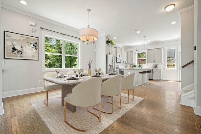2093 Callaway Ct NW, Atlanta, GA 30318 - dining space featuring light wood-style flooring, crown molding, recessed lighting, baseboards, and stairs