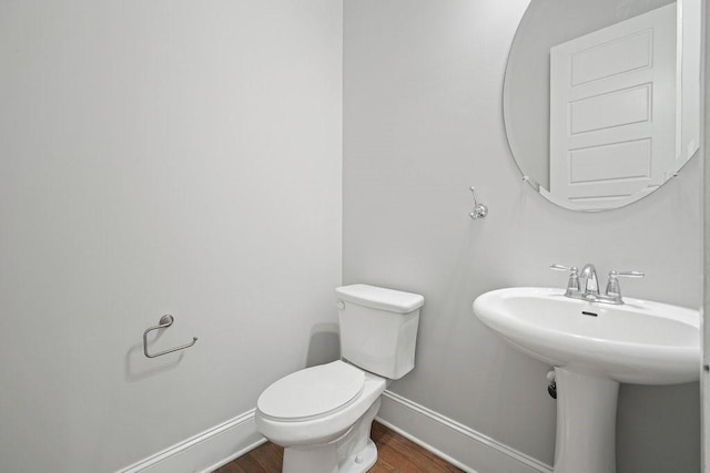 2093 Callaway Ct NW, Atlanta, GA 30318 - half bath with baseboards, wood finished floors, toilet, and a sink