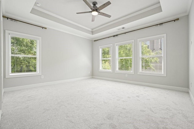 2093 Callaway Ct NW, Atlanta, GA 30318 - spare room featuring crown molding, a tray ceiling, plenty of natural light, a ceiling fan, and carpet flooring