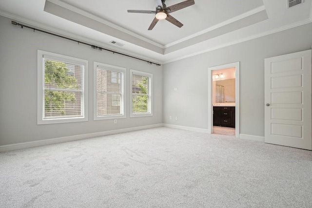 2093 Callaway Ct NW, Atlanta, GA 30318 - unfurnished bedroom featuring crown molding, a tray ceiling, light carpet, baseboards, and connected bathroom