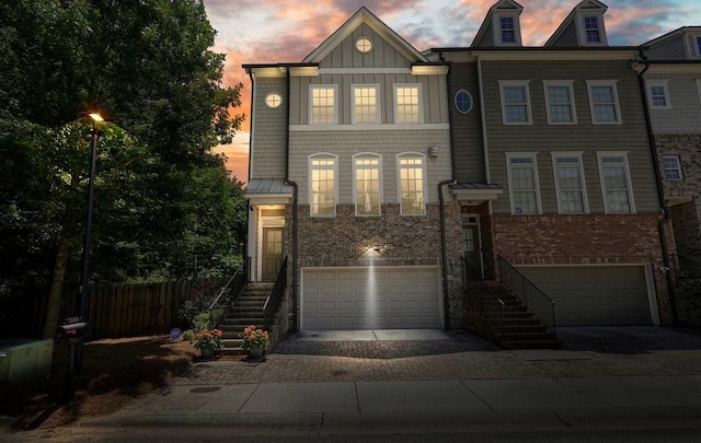 2093 Callaway Ct NW, Atlanta, GA 30318 - view of front of property featuring a garage, driveway, brick siding, and board and batten siding