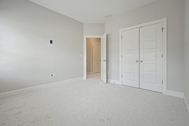 2093 Callaway Ct NW, Atlanta, GA 30318 - unfurnished bedroom with light carpet, baseboards, and a closet