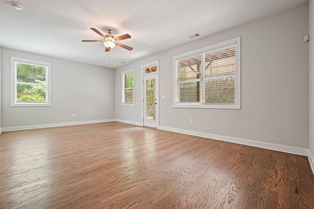 2093 Callaway Ct NW, Atlanta, GA 30318 - spare room with healthy amount of natural light, a ceiling fan, wood finished floors, and baseboards