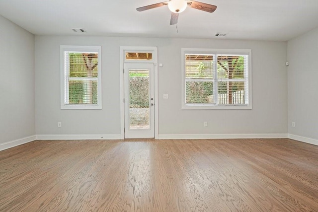 2093 Callaway Ct NW, Atlanta, GA 30318 - unfurnished room featuring light wood-type flooring, healthy amount of natural light, a ceiling fan, and baseboards