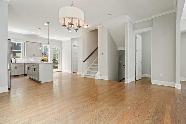 2093 Callaway Ct NW, Atlanta, GA 30318 - unfurnished living room with crown molding, stairs, baseboards, a chandelier, and recessed lighting