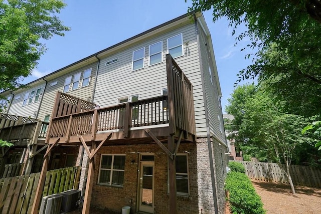 2093 Callaway Ct NW, Atlanta, GA 30318 - rear view of property featuring brick siding, central AC, and a deck