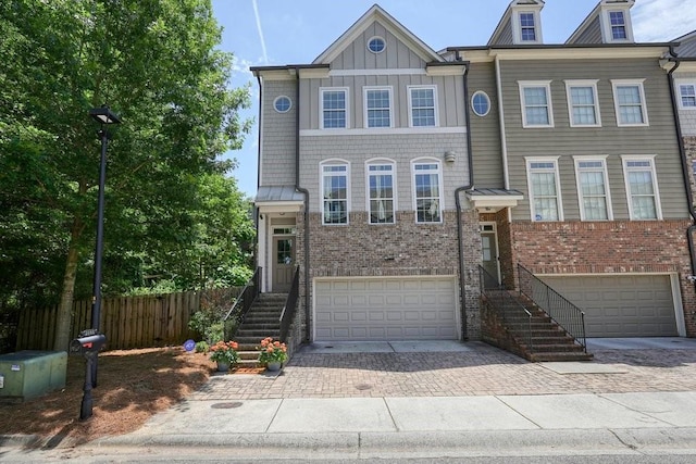 2093 Callaway Ct NW, Atlanta, GA 30318 - multi unit property featuring a garage, driveway, brick siding, and board and batten siding