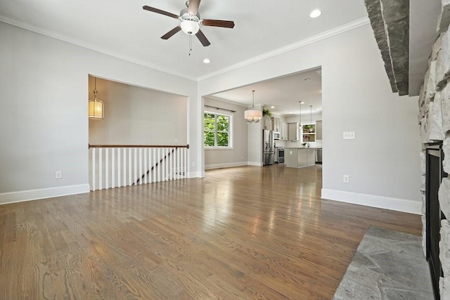 2093 Callaway Ct NW, Atlanta, GA 30318 - unfurnished living room featuring a ceiling fan, crown molding, wood finished floors, a fireplace, and baseboards