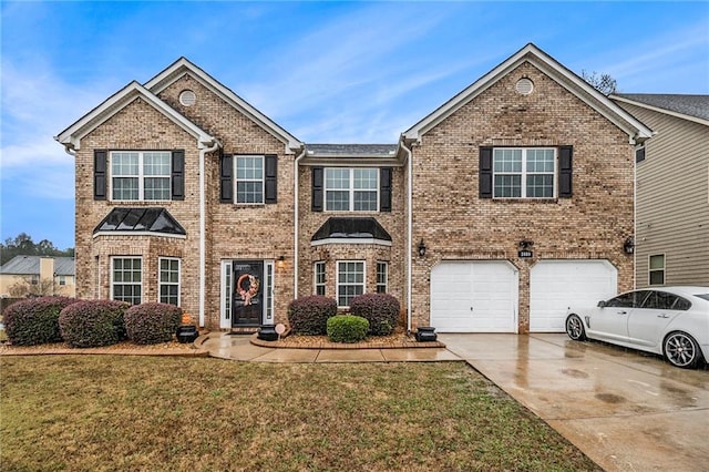 view of front of home featuring a garage and a front lawn