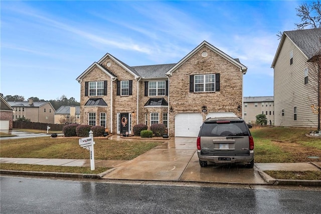 view of front of home with a front lawn and a garage