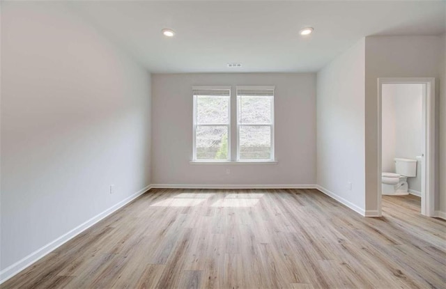 unfurnished room featuring recessed lighting, baseboards, and wood finished floors