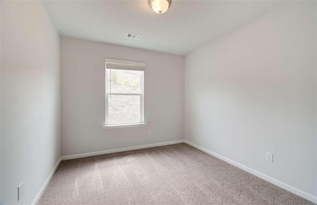 carpeted empty room with baseboards and visible vents