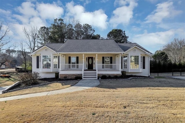 single story home featuring covered porch and a front lawn