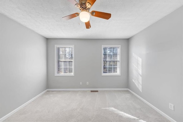 unfurnished room featuring light carpet, a textured ceiling, and ceiling fan