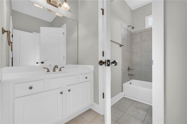 bathroom with tile patterned flooring, vanity, and tiled shower / bath combo