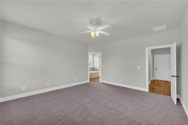 unfurnished bedroom with carpet, ceiling fan, and ensuite bathroom