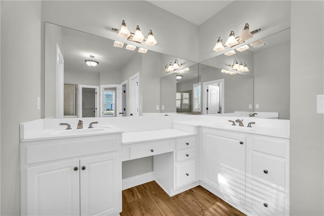 bathroom featuring hardwood / wood-style floors, vanity, and walk in shower