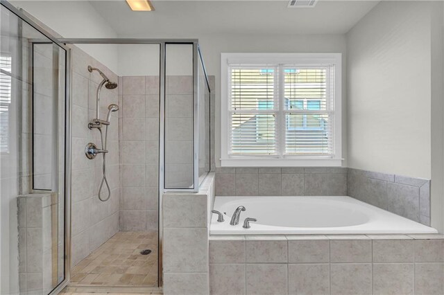 bathroom featuring plus walk in shower
