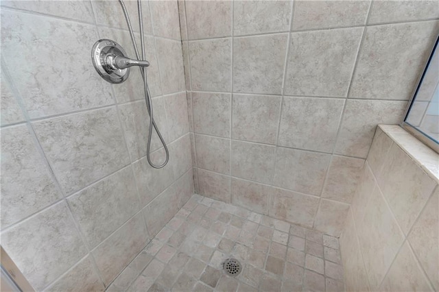 bathroom with a tile shower