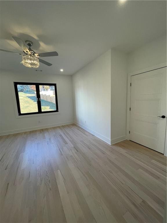 unfurnished room with ceiling fan and light hardwood / wood-style flooring