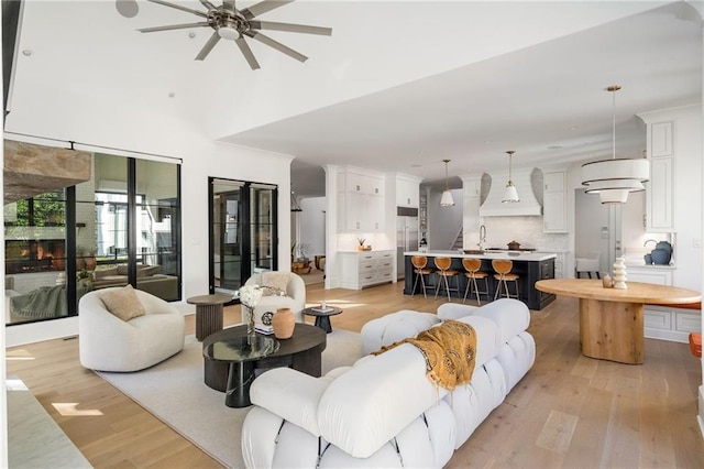 living room with a ceiling fan and light wood-style flooring