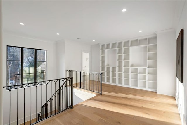 hallway with recessed lighting, crown molding, an upstairs landing, and wood finished floors