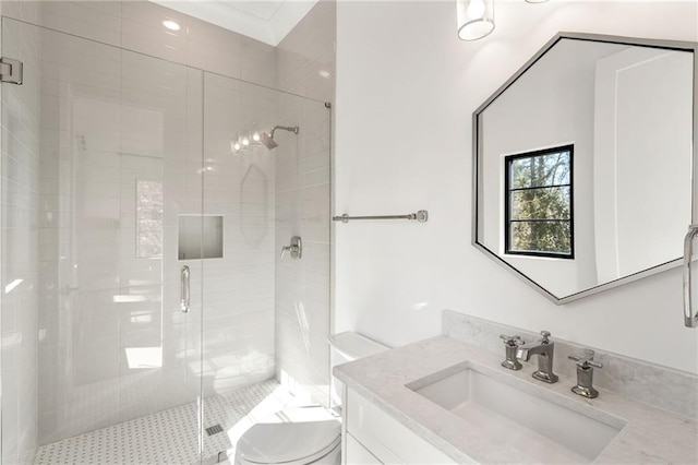 bathroom with vanity, a shower stall, and toilet