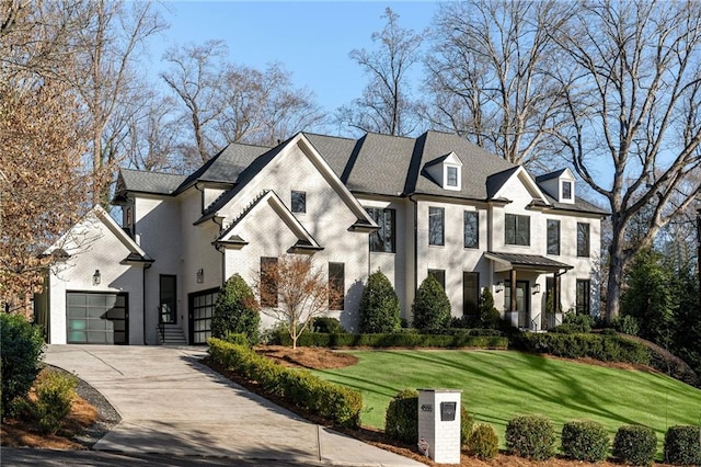 view of front of home featuring concrete driveway, a front lawn, an attached garage, and brick siding