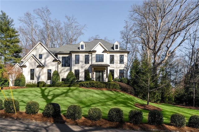 view of front of house featuring a front lawn and stucco siding