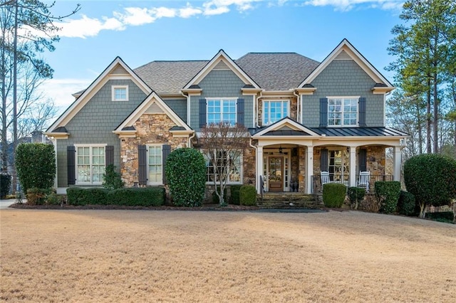 craftsman inspired home with a front yard and a porch