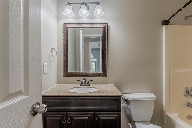 full bath featuring vanity, toilet, and shower / tub combination