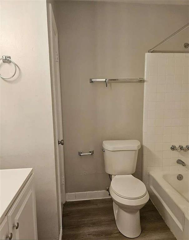 full bathroom featuring wood-type flooring, vanity, toilet, and shower / washtub combination