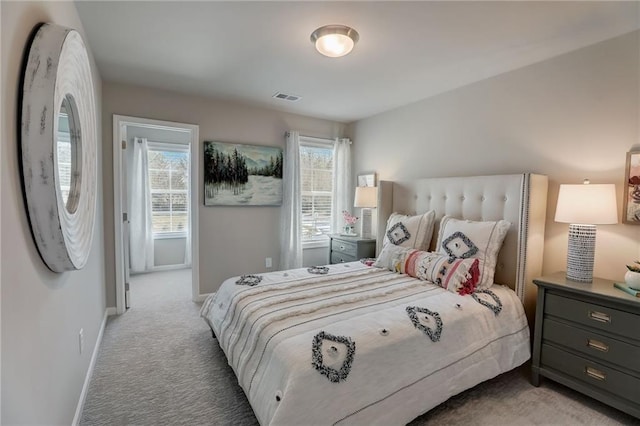 carpeted bedroom featuring multiple windows