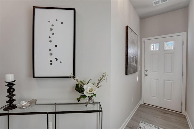 entryway with light hardwood / wood-style floors