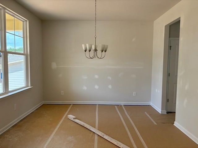 385 Riverwood Pass, Dallas, GA 30157 - unfurnished dining area with a chandelier and baseboards