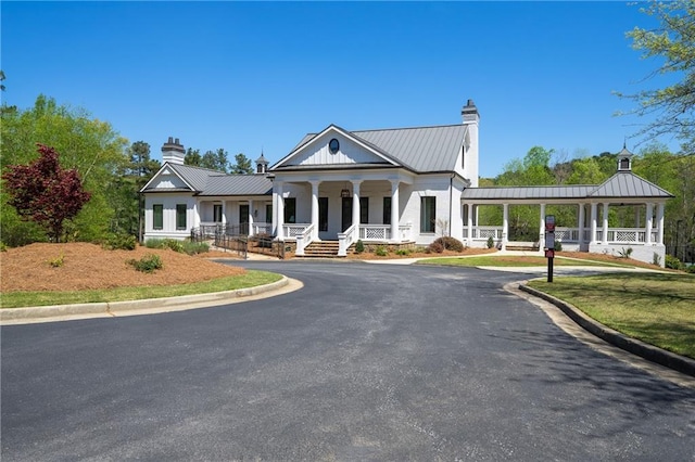 385 Riverwood Pass, Dallas, GA 30157 - view of front of property with a chimney, covered porch, a standing seam roof, and a metal roof