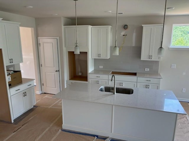385 Riverwood Pass, Dallas, GA 30157 - kitchen featuring tasteful backsplash, white cabinetry, an island with sink, and light stone countertops