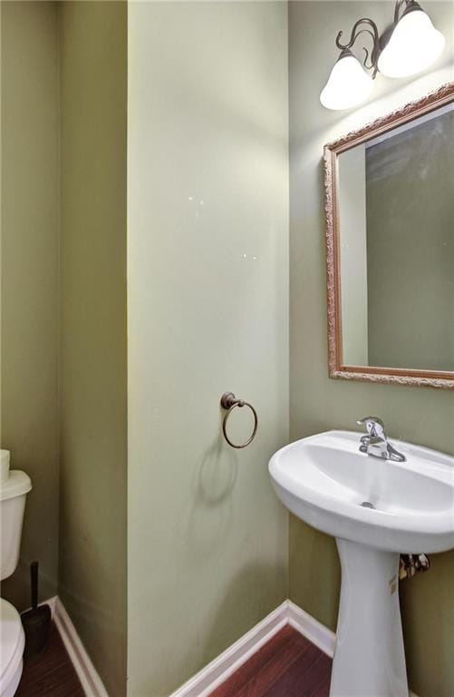 bathroom with wood-type flooring and toilet