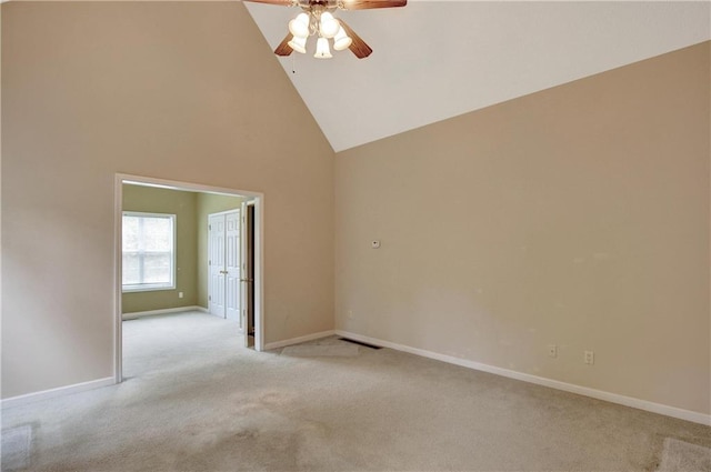 carpeted empty room featuring high vaulted ceiling and ceiling fan