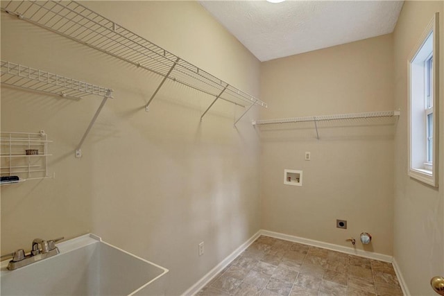 clothes washing area featuring sink, washer hookup, hookup for an electric dryer, gas dryer hookup, and a textured ceiling