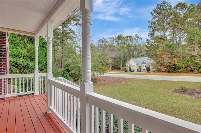 deck with covered porch and a yard