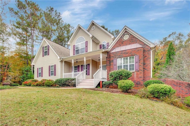 view of property with a porch and a front lawn