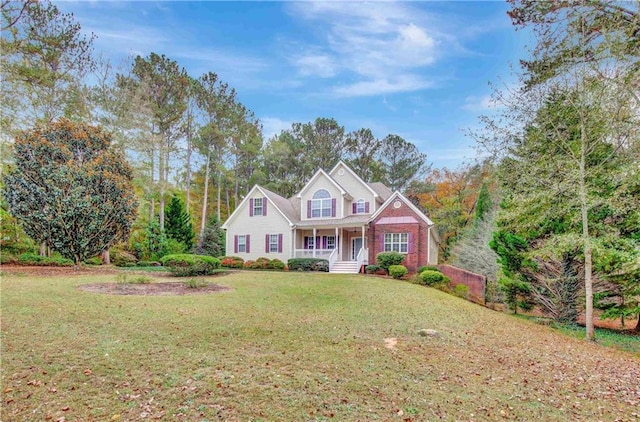 view of front facade featuring covered porch and a front yard