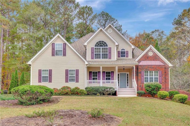 view of front of property featuring covered porch and a front yard