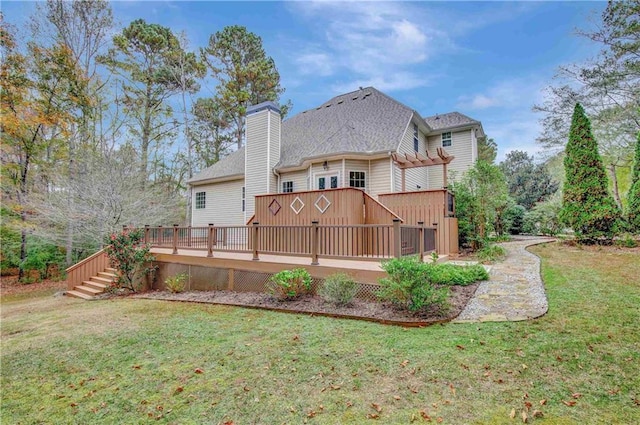 rear view of house featuring a lawn and a wooden deck