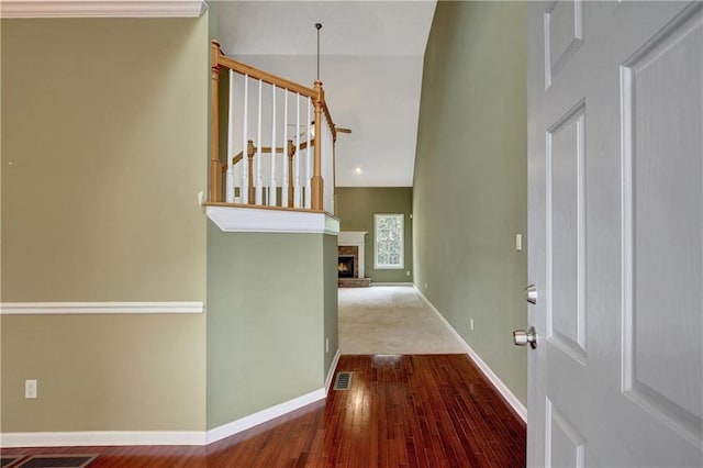 entrance foyer with wood-type flooring and a brick fireplace